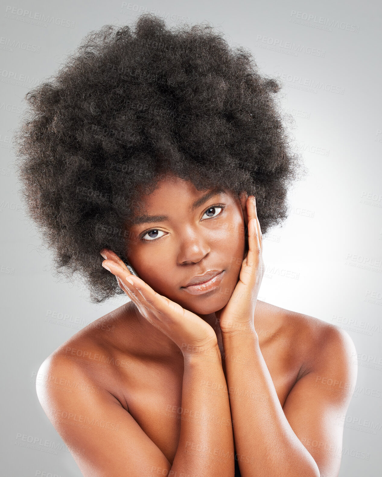 Buy stock photo Portrait, afro and black woman in studio for wellness, dermatology and results for skincare. Hands, model girl and natural hair for beauty, cosmetics and aesthetic or self care by grey background