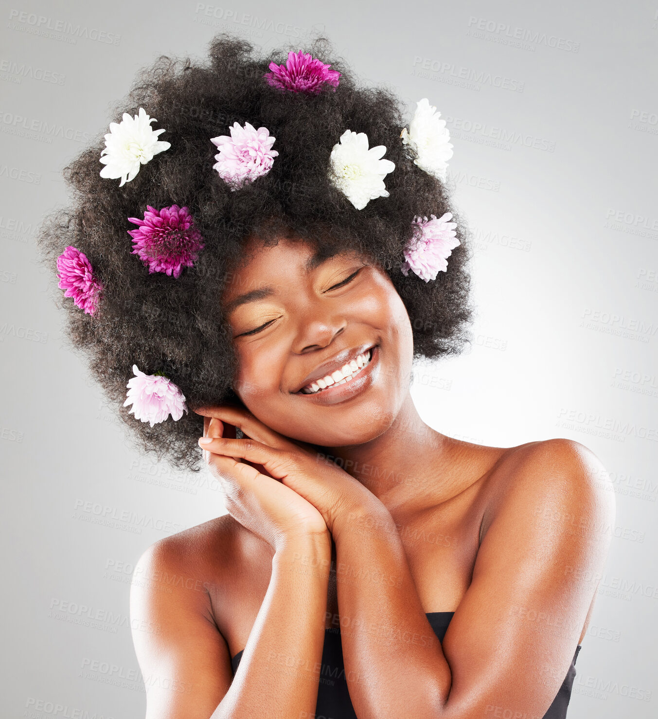 Buy stock photo Black woman, studio or flowers for natural haircare or skin, beauty transformation for wellness. Female person, floral plants or cosmetic with white background for salon or afro treatment in Kenya