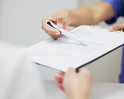 Buy stock photo Shot of two unrecognizable people discussing a contract in a office
