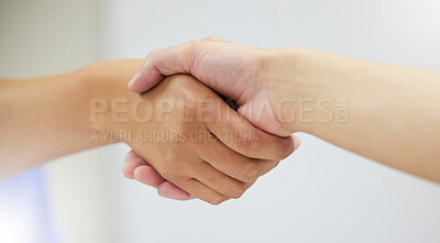 Buy stock photo Shot of two unrecognizable people shaking hands in a clinic
