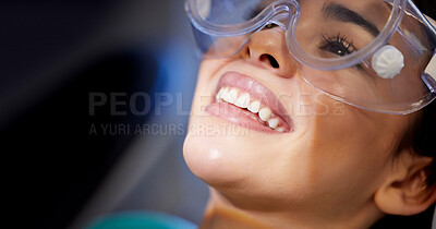 Buy stock photo Shot of a young woman wearing goggles during a dental procedure
