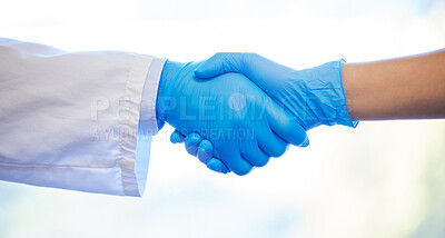 Buy stock photo Shot of two unrecognisable dentists wearing gloves and shaking hands
