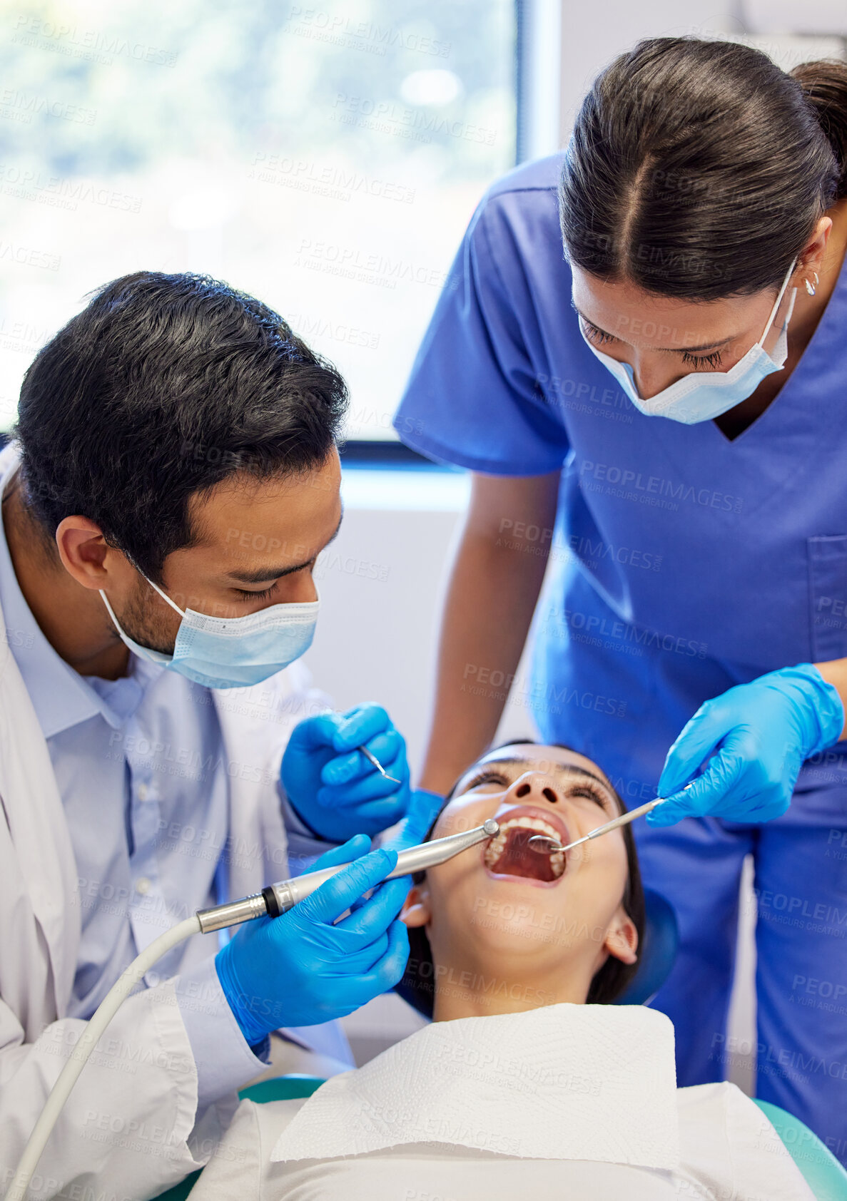 Buy stock photo Dentist, oral care and procedure with patient for healthcare, wellness and teeth whitening in practice. Woman, ppe and dental professional with tools for consultation, cleaning and filling on chair