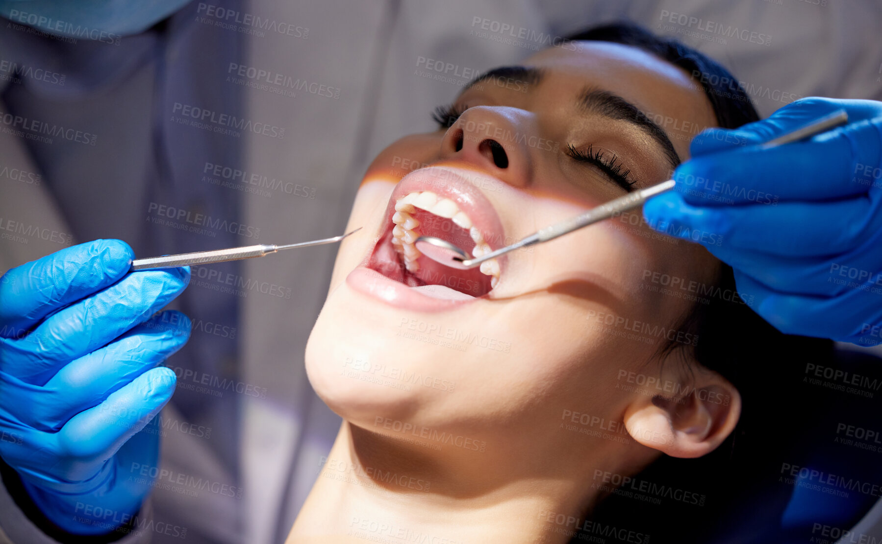 Buy stock photo Face, hands and tools with woman at dentist for oral hygiene or dental care appointment closeup. Checkup, healthcare and medical equipment with patient in chair at clinic for mouth cleaning or exam