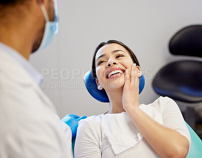 Buy stock photo Shot of a young woman looking satisfied after having a dental procedure performed on her
