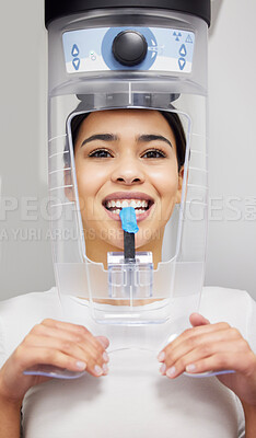 Buy stock photo Shot of a young woman using an x ray machine at a dentist’s office