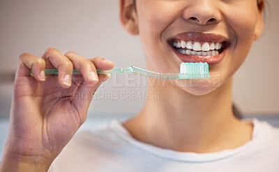 Buy stock photo Shot of an unrecognisable woman brushing her teeth at home