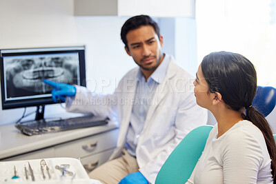Buy stock photo Shot of a dentist discussing the results of a patient’s teeth x ray