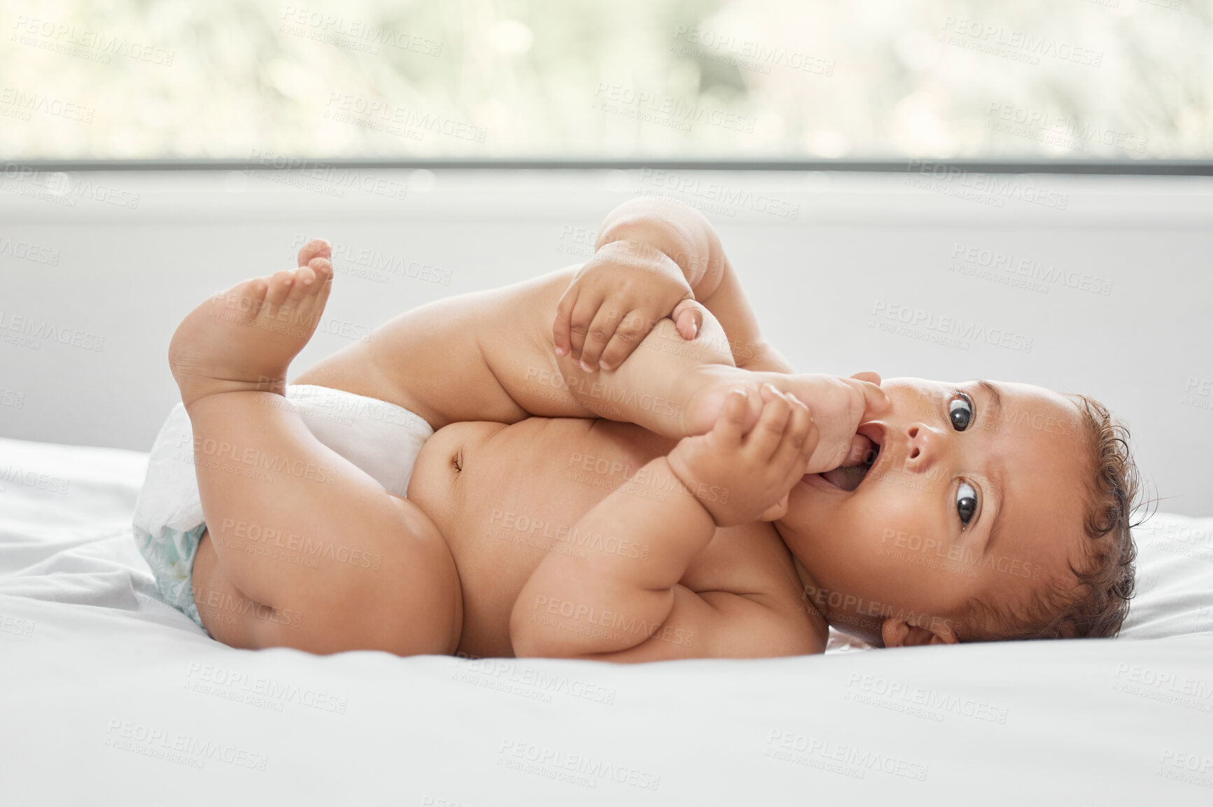 Buy stock photo Baby, portrait and child sucking feet on bed in home having fun and enjoying time alone. Face, newborn and playing with foot, toes and cute infant, kid or toddler with growth, development and relax