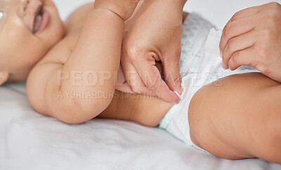 Buy stock photo Mother, hands and changing diaper in home, secure baby and love for infant or routine dressing. Mama, child and care for kid in bedroom or cleaning, support and helping with hygiene or sanitary