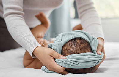 Buy stock photo Woman, hands and dressing baby in clothes in home for morning, care and support for newborn. Mom, child and together in bedroom for love, helping and parent with routine for growth and development 