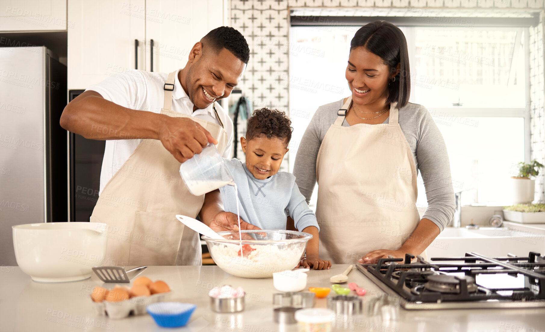 Buy stock photo Family, kid and parents baking with milk in kitchen for learning, teaching and help happy boy. Mother, father and child pour dairy for cooking with flour for dessert recipe, cookies and food in home