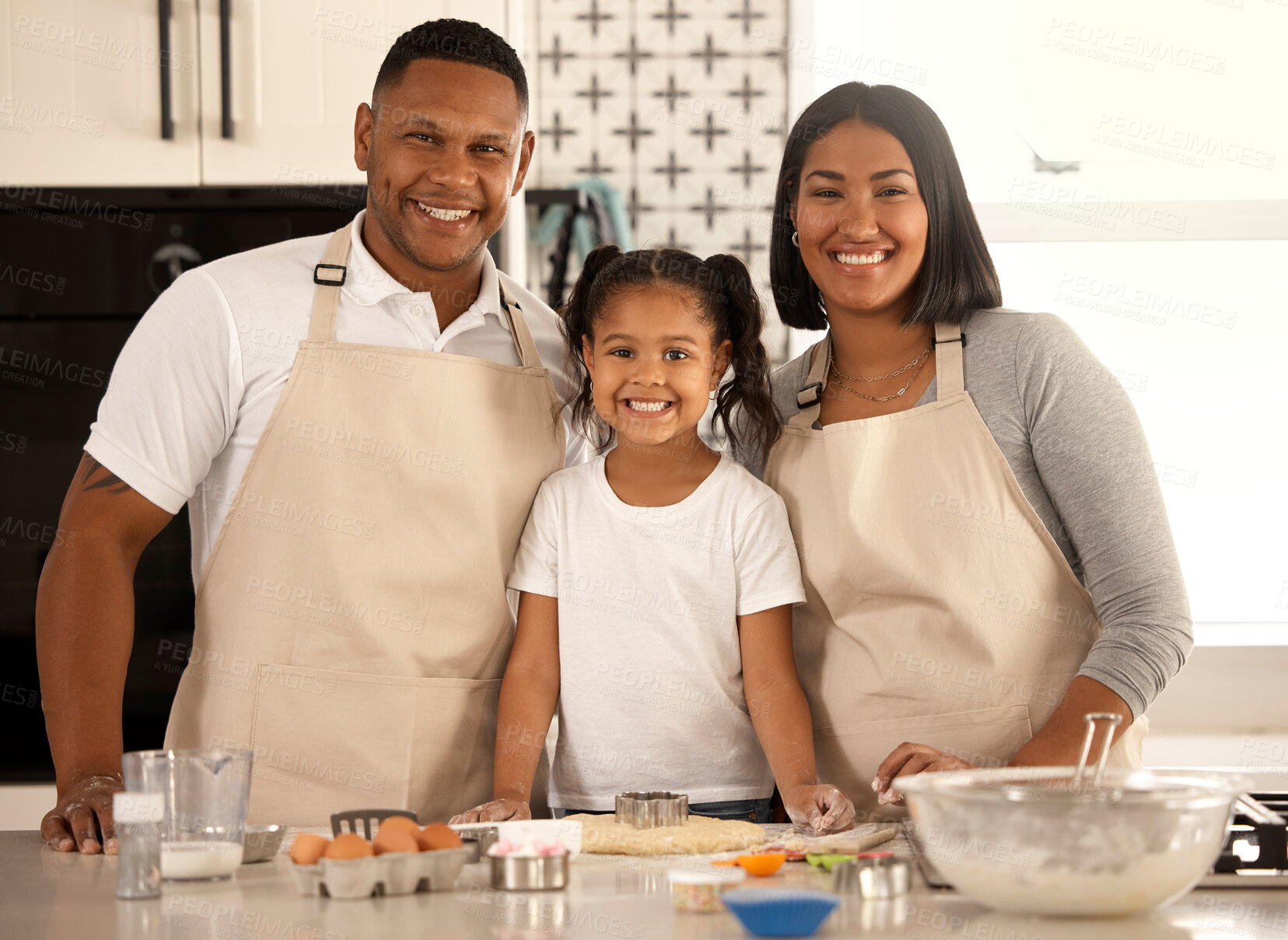 Buy stock photo Portrait of an adorable little girl baking with her parents at home