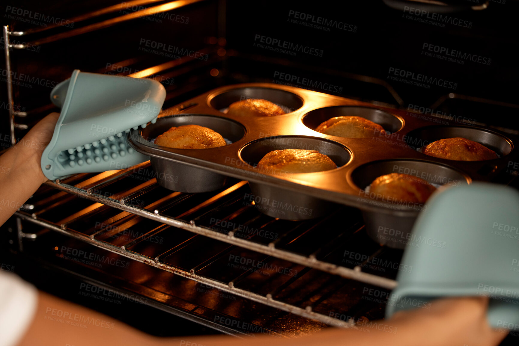 Buy stock photo Muffins, oven and hands with tray for baking, culinary skills with kid in home with mitts on for heat safety. Caution, weekend break and cupcakes recipe or child development, fresh treat and kitchen