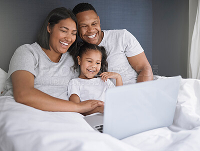 Buy stock photo Happy family, girl and relax with laptop in bedroom for chill or unwind on weekend, morning and online for movies. Mother, father and child in home with internet for streaming, video and cartoon film