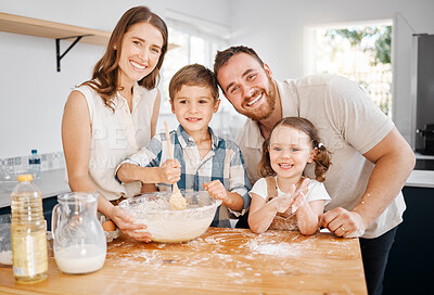 Buy stock photo Shot of a couple and their two children baking together at home