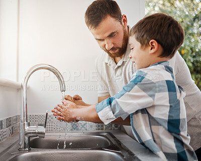 Buy stock photo Shot of a man and his young son washing their hands at home