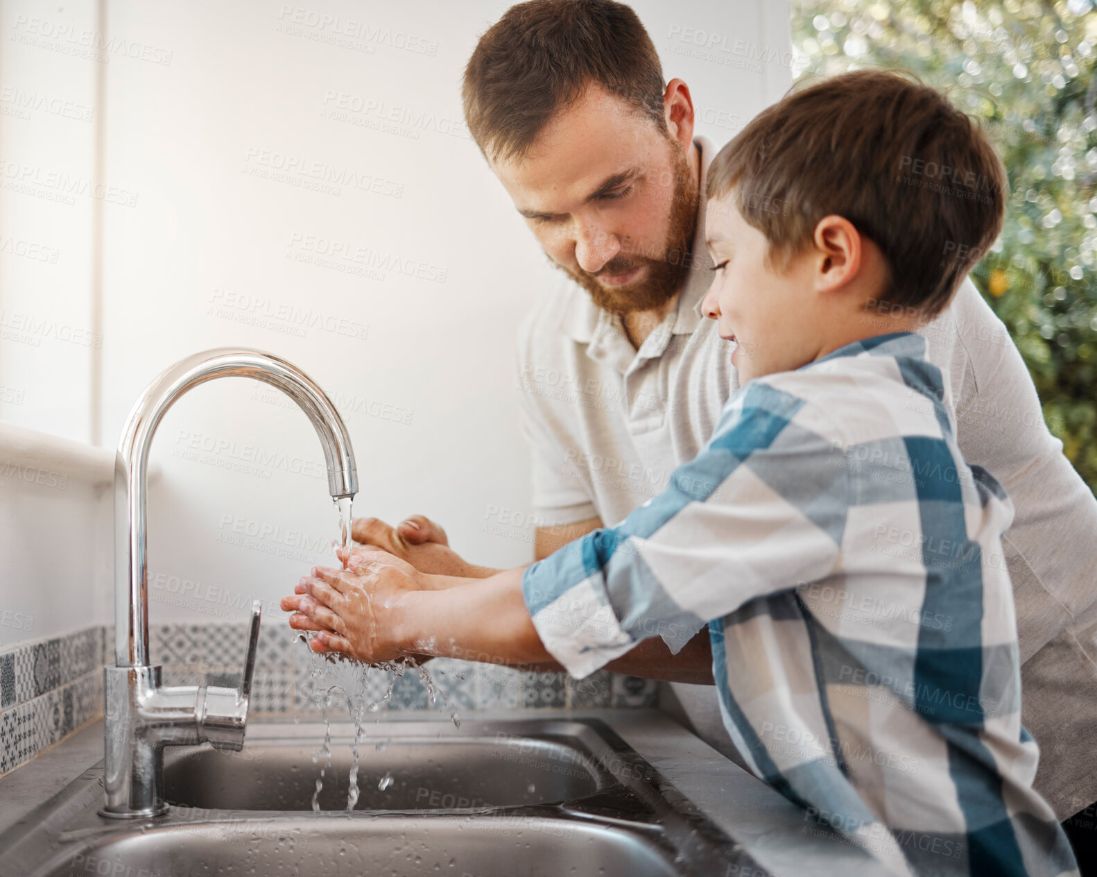 Buy stock photo Shot of a man and his young son washing their hands at home