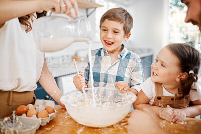 Buy stock photo Shot of a couple and their two children baking together at home