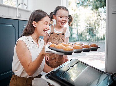 Buy stock photo Shot of a woman baking with her daughter at home
