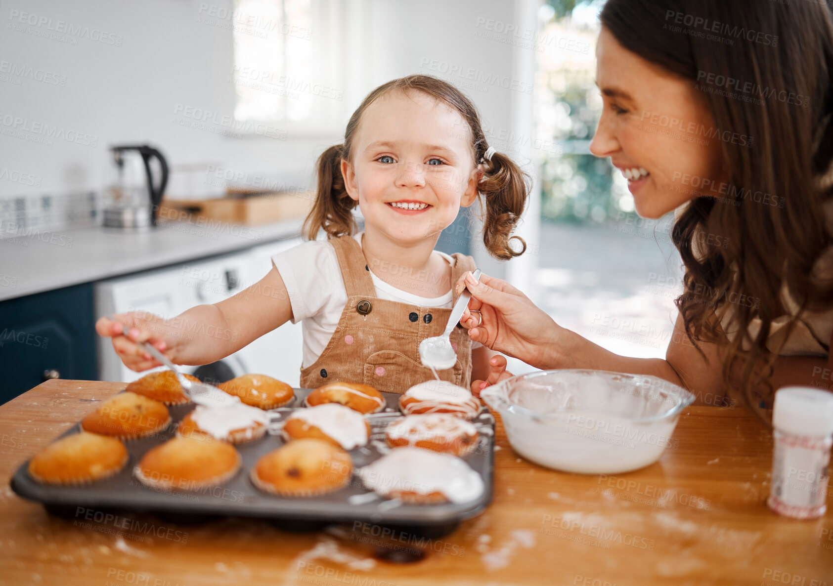 Buy stock photo Shot of a woman baking with her daughter at home