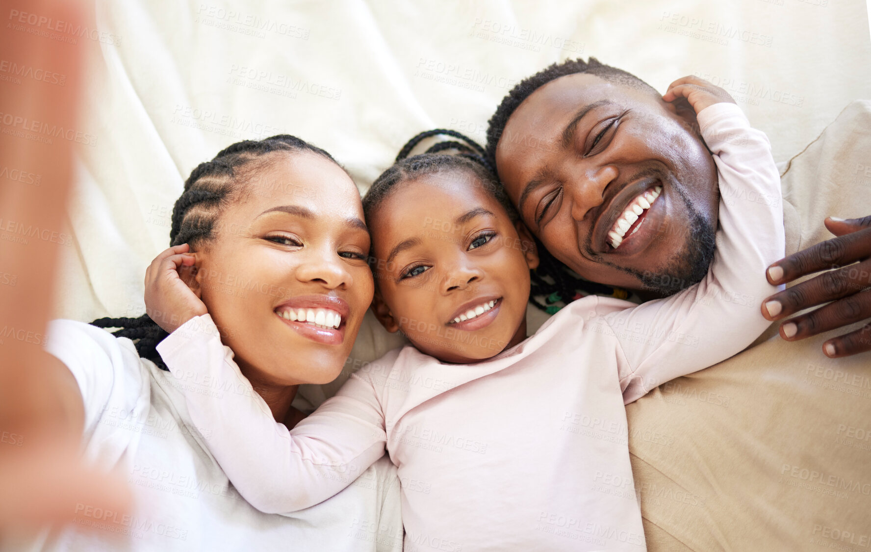 Buy stock photo African family, portrait and selfie of happy child in bedroom with parents to relax in home above. Face, mother and father with girl kid in top view for picture, laughing or embrace for love together