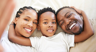 Buy stock photo Black family, portrait and selfie of happy kid with parents in bedroom to relax in home above. Face, mother and father with boy child in top view for picture, laughing and embrace for love together