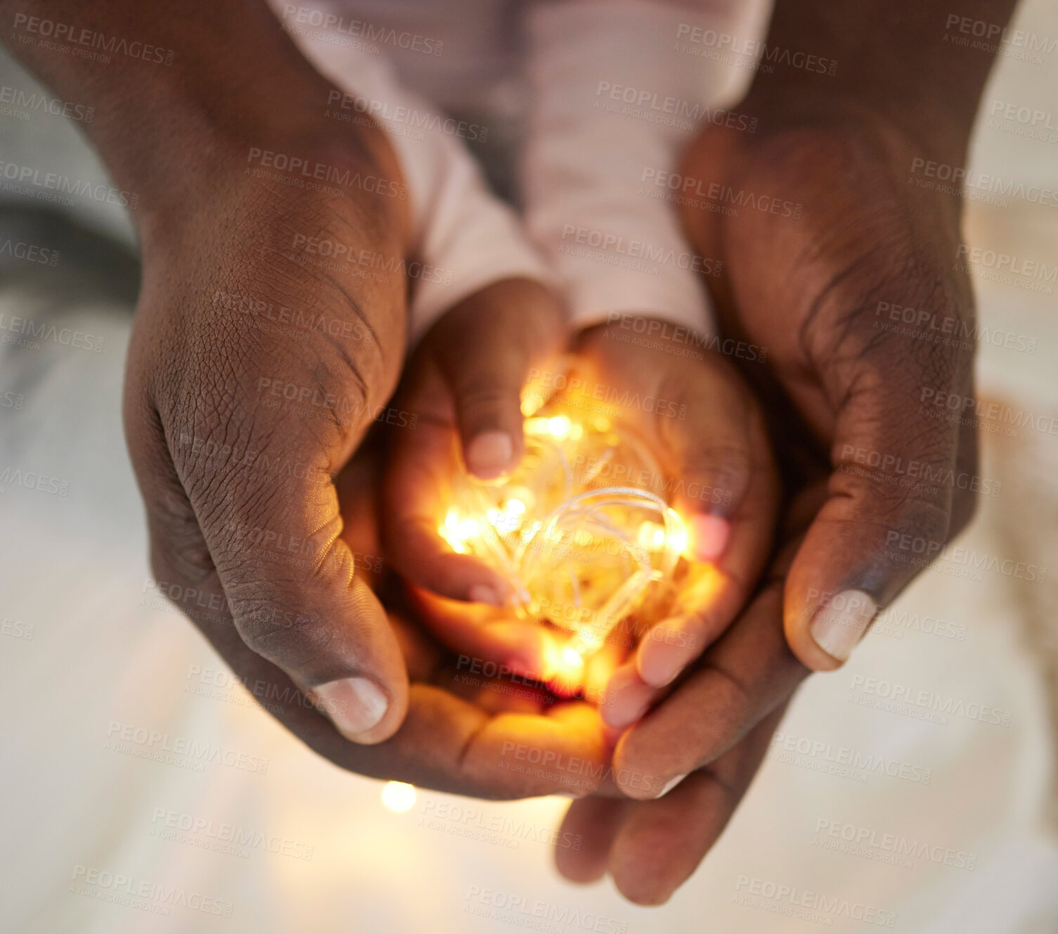 Buy stock photo Hands, light and child with person, bright and future of youth with parent to nurture in house with love. Peace, care and closeup of toddler with father as guide, palm and careful with knowledge