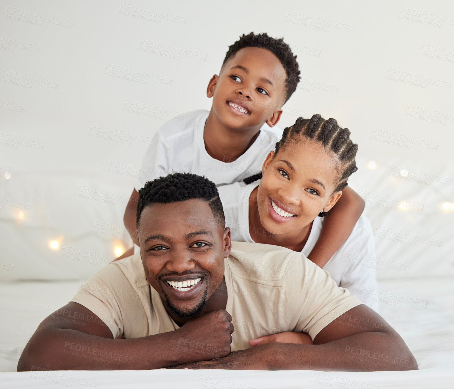 Buy stock photo Black family, portrait and smile of kid in bedroom with parents to relax in home. Face, mother and father with boy child in bed for support, connection and bonding together for healthy relationship