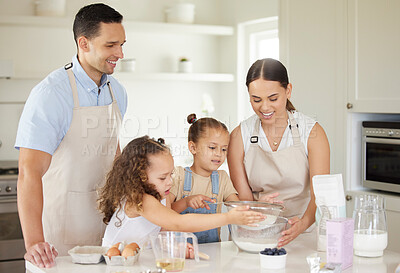 Buy stock photo Shot of a young family baking together at home