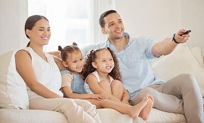 Buy stock photo Shot of a man using a tv remote while watching something at home with his family