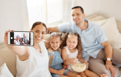 Buy stock photo Shot of a woman taking a selfie at home with her family