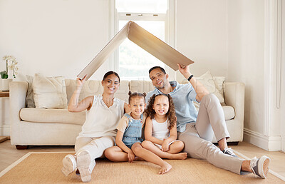 Buy stock photo Shot of a young family holding a cardboard box to form a roof over their heads