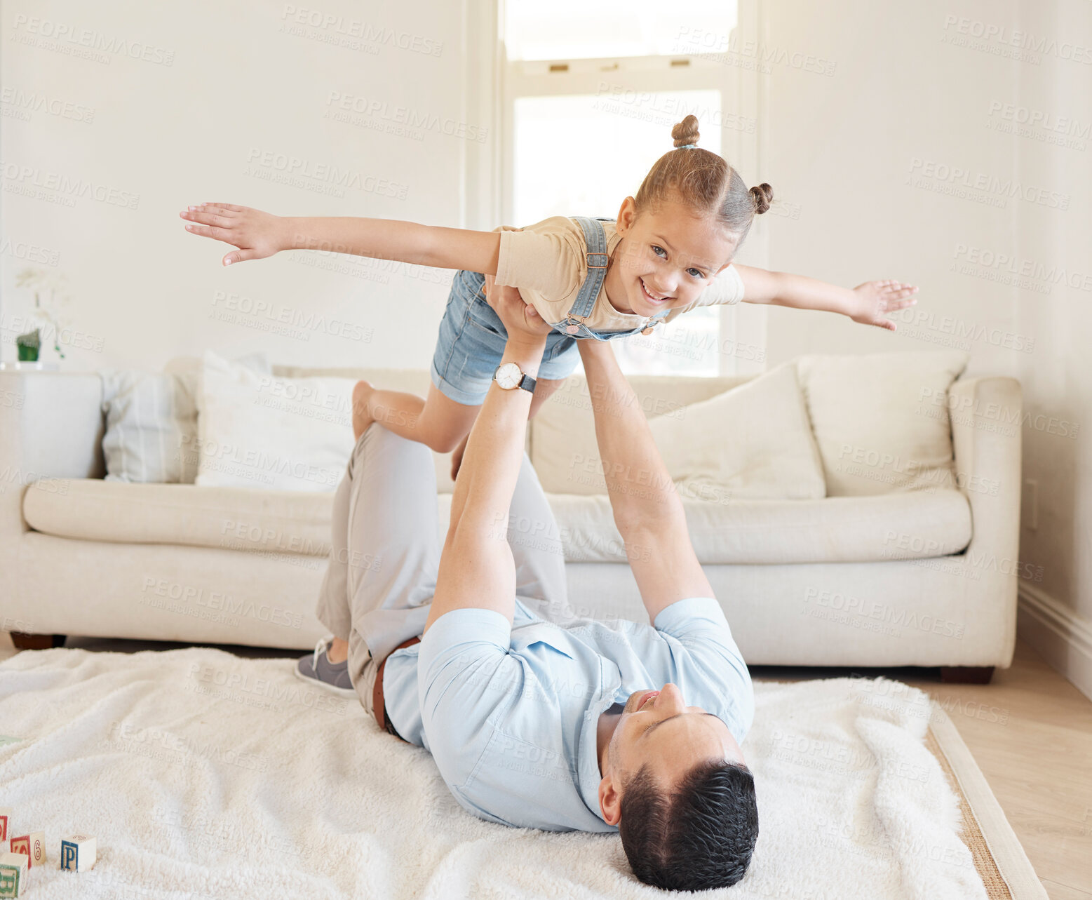 Buy stock photo Shot of a man bonding with his adorable daughter at home