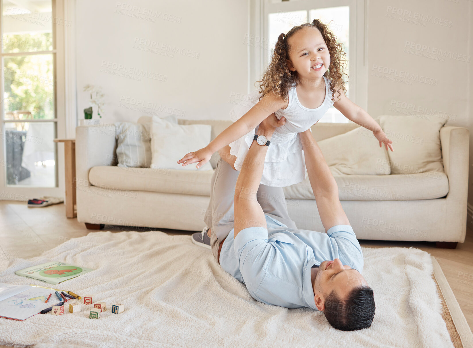 Buy stock photo Shot of a man bonding with his adorable daughter at home