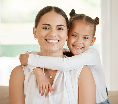 Buy stock photo Shot of a young woman sitting at home with her daughter