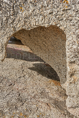 Buy stock photo Closeup of rough rock with deep cracks, holes and crevices from wind, heat or water erosion from global warming or climate change. Texture detail and background of sedimentary rock or granite outside