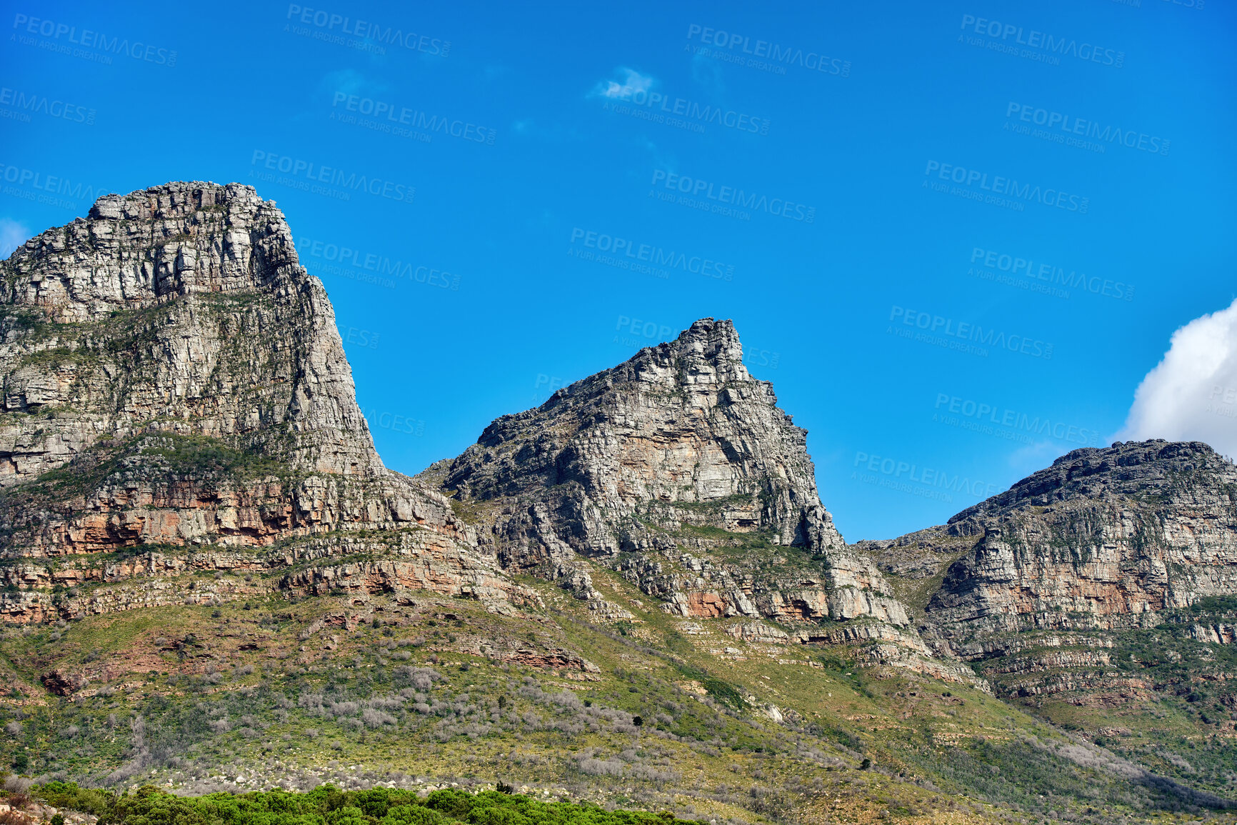 Buy stock photo Beautiful outdoor mountain landscape with a blue sky copyspace in nature. Outside view of high mountains, green grass, and plant life. Relaxing natural background of rock formations on a summer day