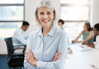 Buy stock photo Portrait of a confident mature businesswoman standing with her arms crossed in an office