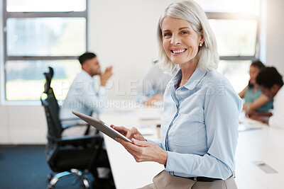 Buy stock photo Portrait of a confident mature businesswoman using a digital tablet in an office