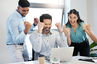 Buy stock photo Shot of a group of businesspeople cheering while using a laptop together in an office