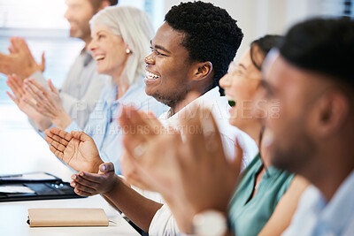 Buy stock photo Shot of a young businessman applauding with his colleagues during a meeting in an office