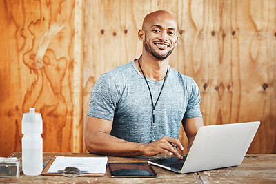 Buy stock photo Portrait of a muscular young man using a laptop while working in a gym
