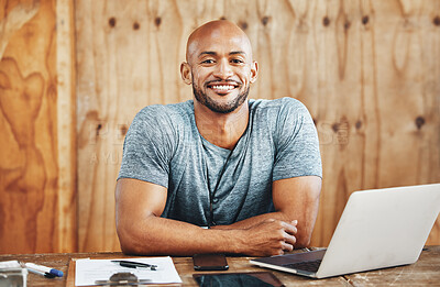 Buy stock photo Portrait of a muscular young man using a laptop while working in a gym