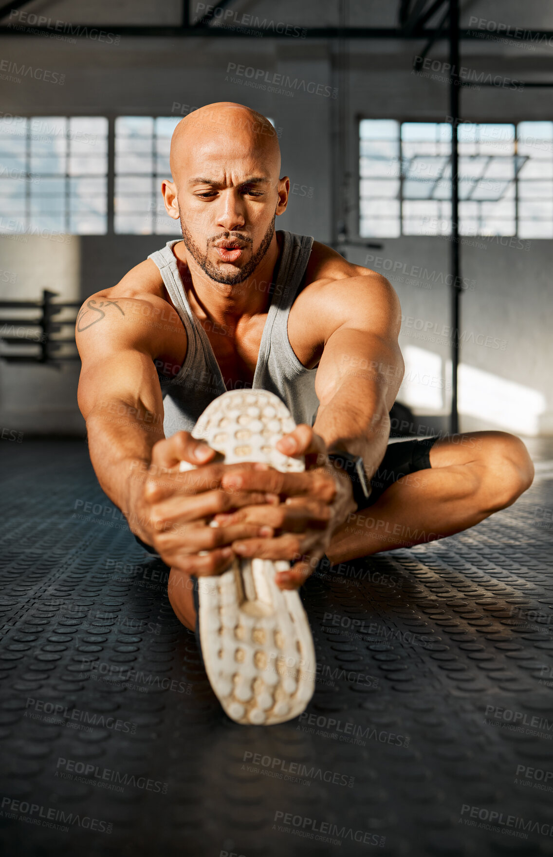 Buy stock photo Endurance, man and legs with stretching for training, balance and prevention of muscle tension. Gym floor, exercise and bodybuilder with warm up for wellness, workout journey or breathing for fitness