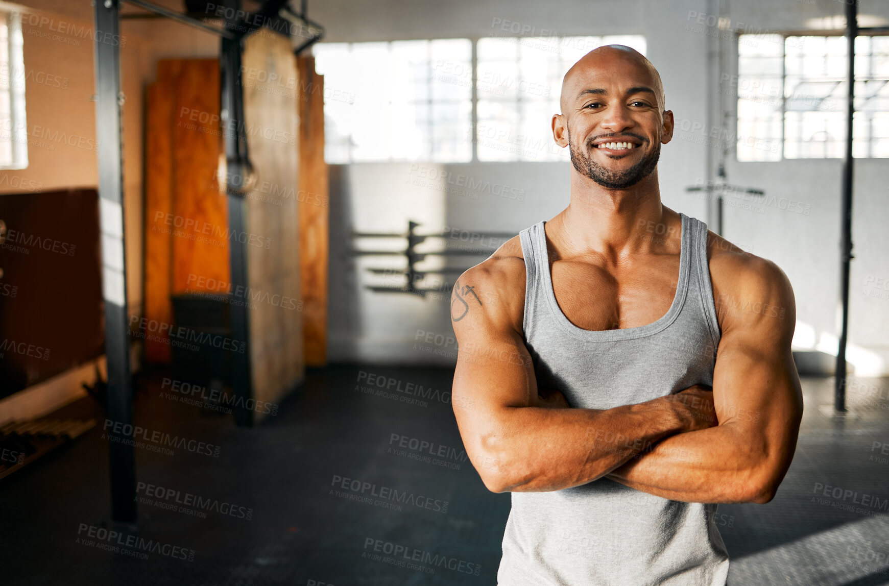 Buy stock photo Portrait, fitness and happy man with arms crossed in gym for workout, body health and wellness. Face, smile and confident African bodybuilder, personal trainer and strong athlete with muscle in Kenya