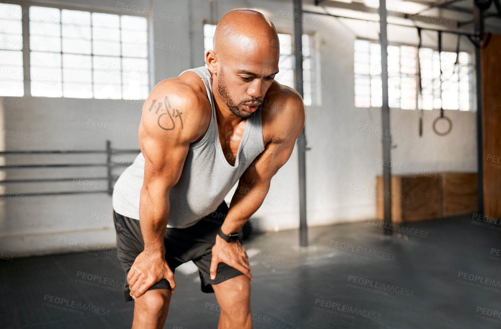 Buy stock photo Breathing, rest and fitness with African man on break from training, workout and exercise in gym. Sweating, health and wellness club with tired athlete and fatigue from endurance with recovery