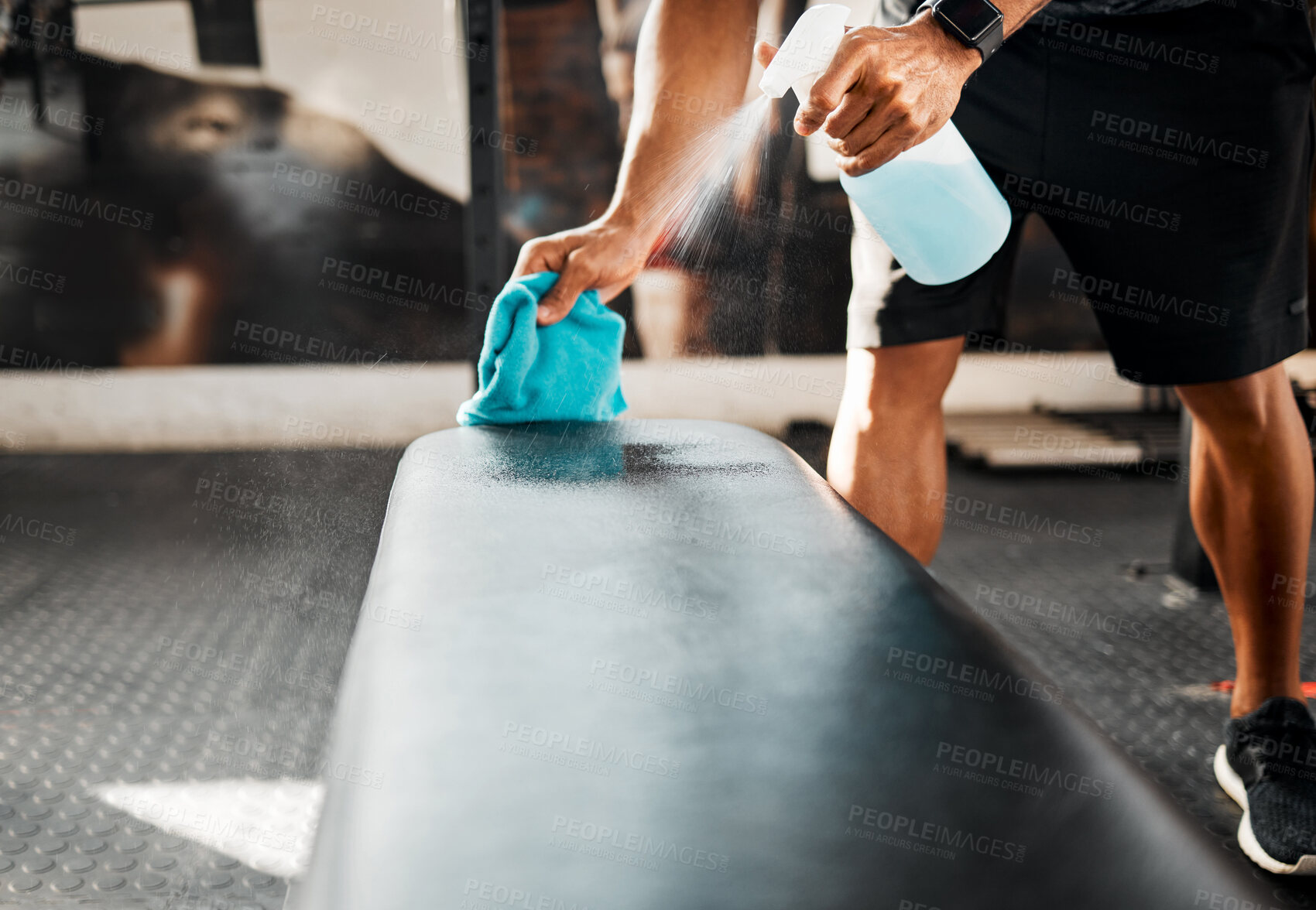 Buy stock photo Shot of a business owner sanitizing the work benches in their gym
