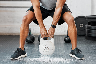 Buy stock photo Shot of a man completing squats with a kettlebell