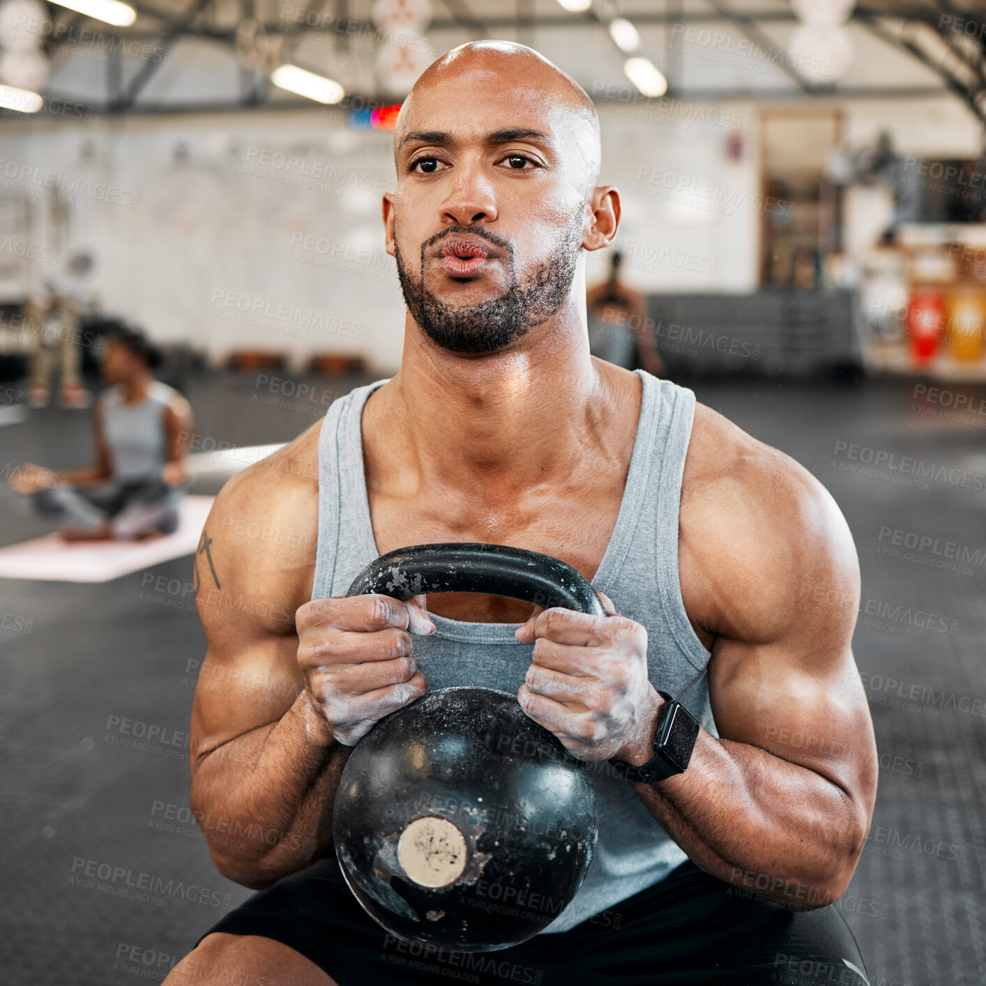 Buy stock photo Shot of a man completing squats with a kettlebell